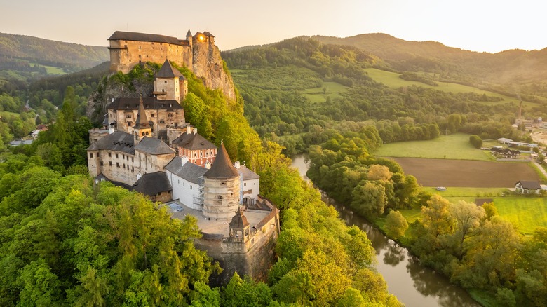 Ancient medieval castle on a hilltop overlooking the Slovak countryside and a river