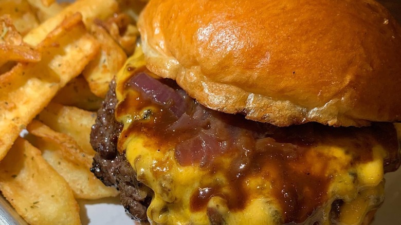 Close up of a burger with onions and cheese from Hundred Burgers in Valencia, Spain.