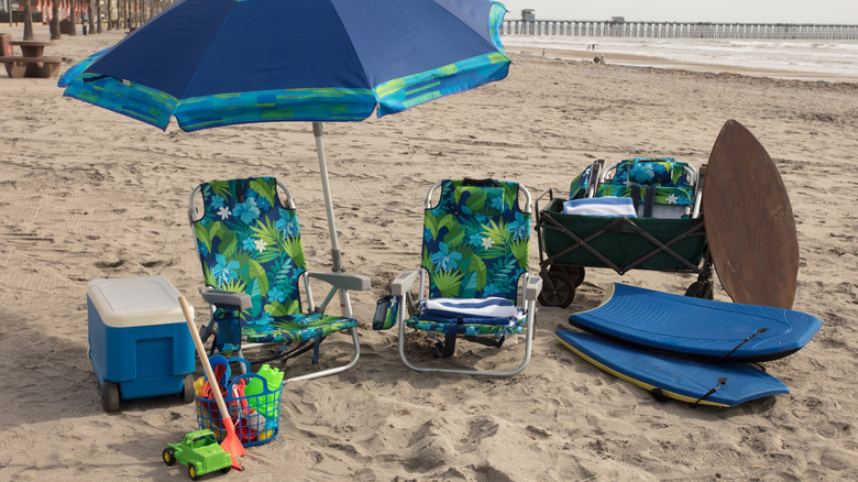 Cooler under umbrella with gear