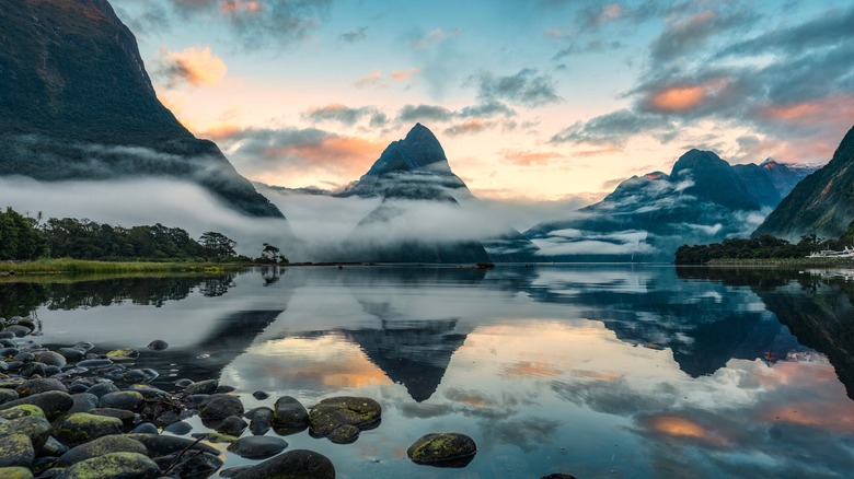 Mountains level with clouds reflected in lake at Fiordland