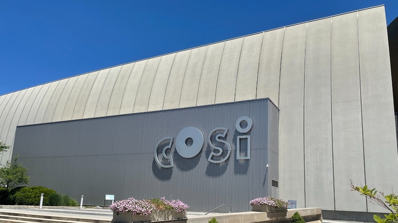 The beige and gray front facade of the Center of Science and Industry (COSI) in Columbus, Ohio.