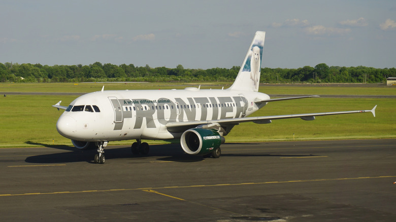 A Frontier Airlines passenger plane taxiing along the runway at Trenton-Mercer Airport.