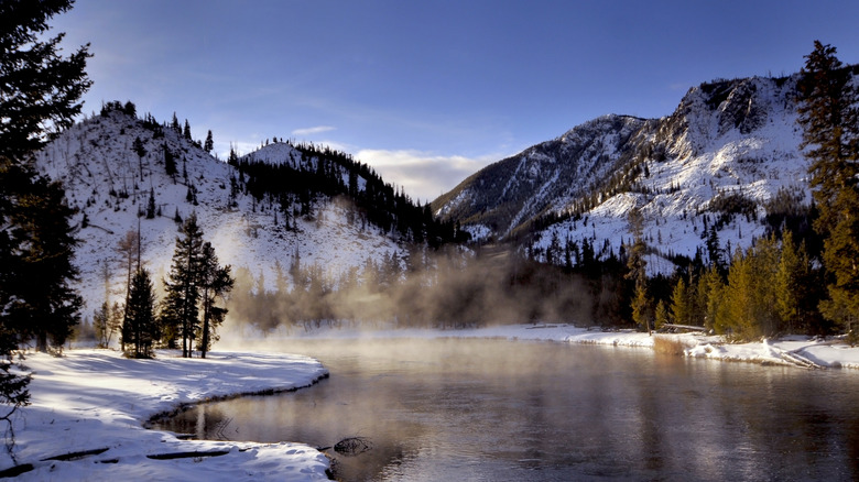 A river surrounded by snow in Yellowstone National Park