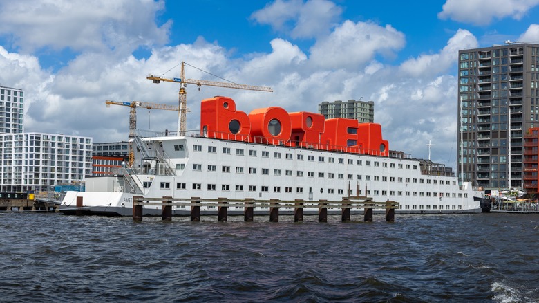 A floating hotel on NDSM Wharf with the word "Botel" on the deck in red