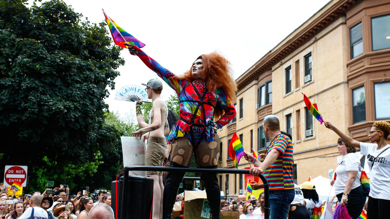 A drag queen holds a rainbow flag at a pride celebration in Chicago