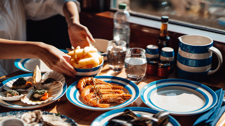 Table with multiple seafood dishes