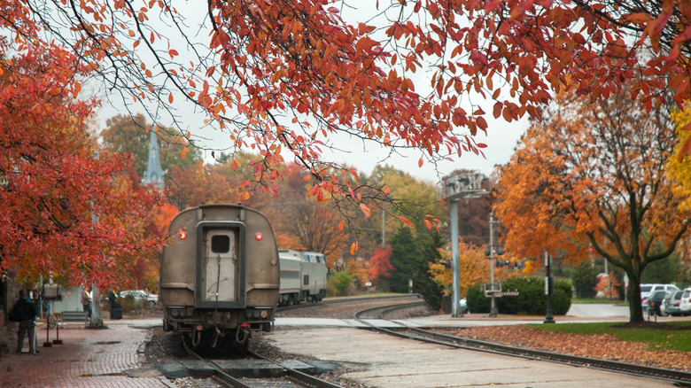A train departing from the historic Kirkwood Train Station in autumn in Kirkwood, MO