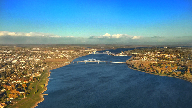 Columbia River flows through tri-state cities under blue sky