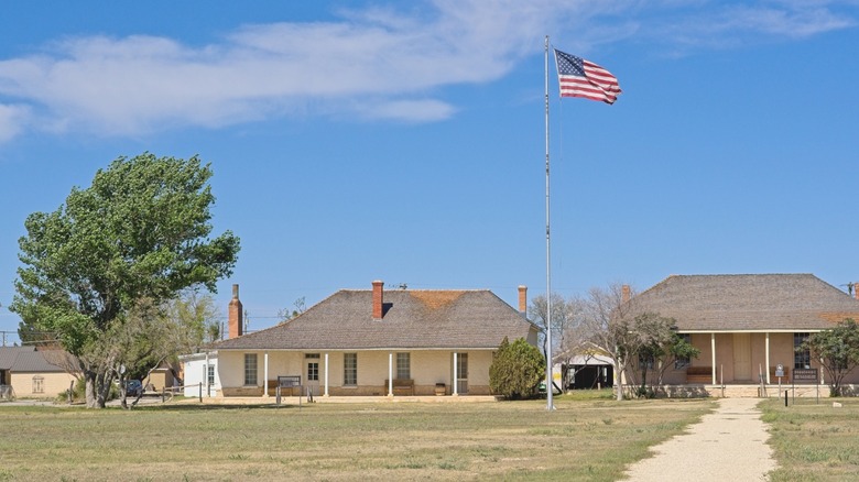 two buildings and an american flag