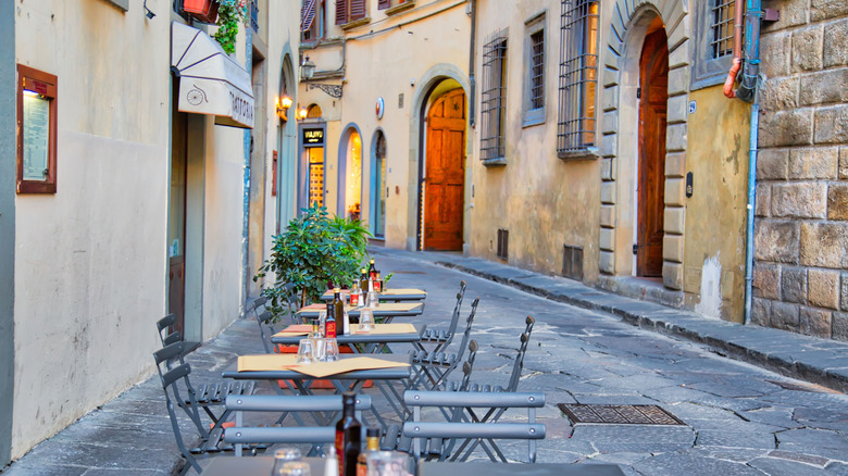 Outdoor café tables near the Ponte Vecchio in Florence, Italy