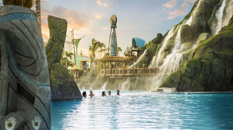 Guests swim in the clear blue waters of Volcano Bay