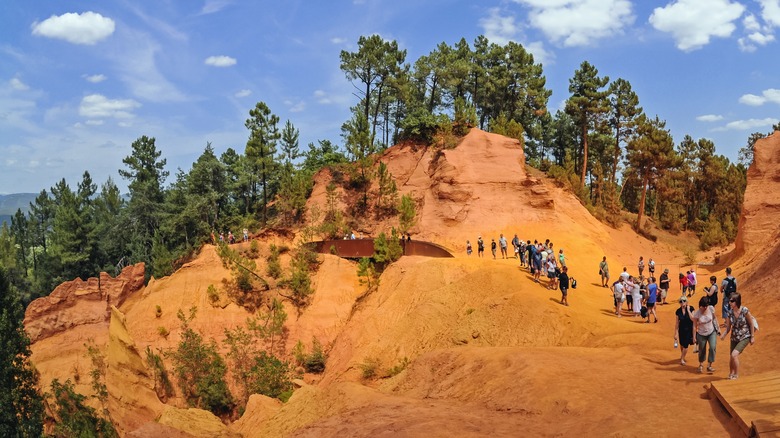 Tourists exploring the hills of Roussillon's Ochre Trails