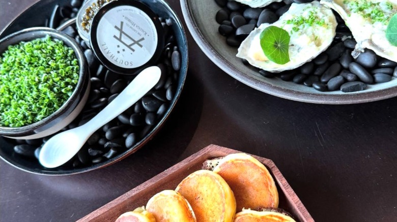 Pancakes and oysters delicately plated on the table at Southall Farm & Inn.