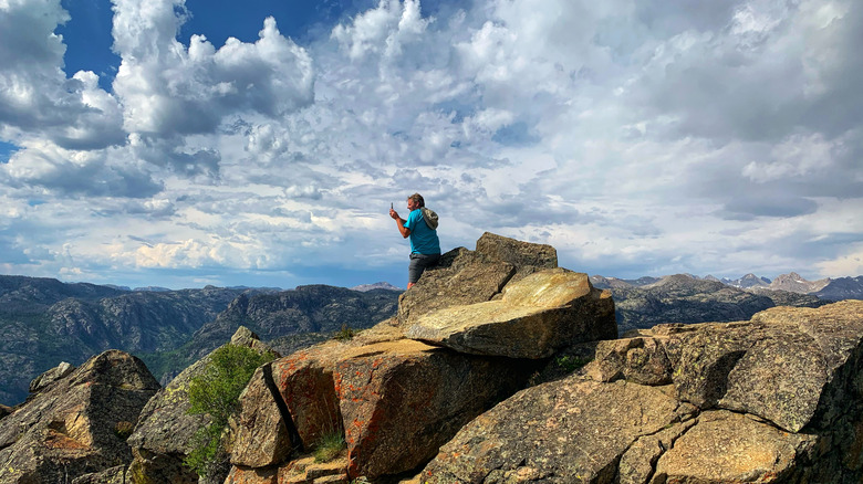 Man taking photos at a lookout in the Sacred Rim Trailhead near Pinedale, Wyoming