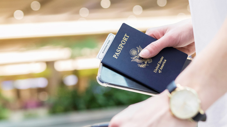 A traveler holding a U.S. passport