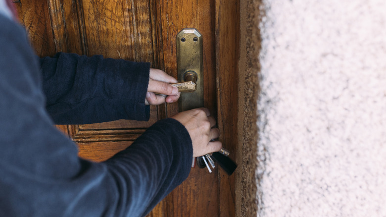 Person unlocking door with keys