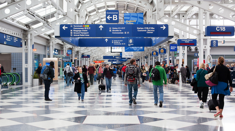 people walk in international terminal of Chicago O'Hare Airport