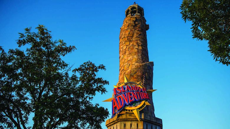 Low-angle view of the Pharos Lighthouse, the tower at the Port of Entry land inside Islands of Adventure, one of the theme parks that make up Universal Orlando Resort in Florida, USA, pictured here on a bright cloudless day