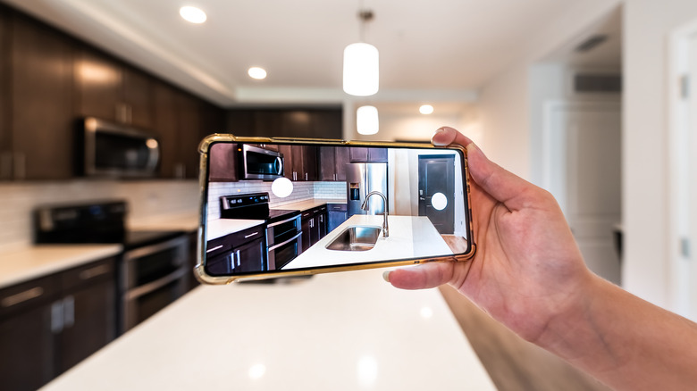 Person takes photo of clean kitchen