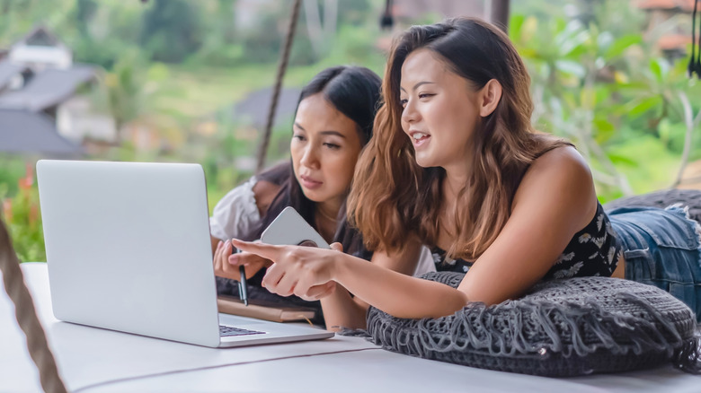 Women looking at rentals on a laptop