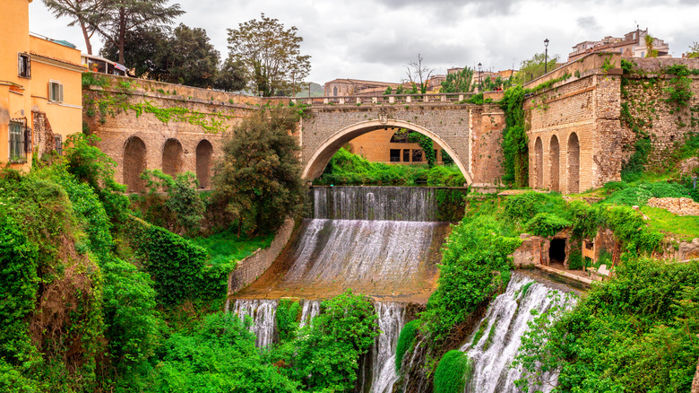 Waterfall going under a bridge at Villa Gregoriana in Tivoli, Italy
