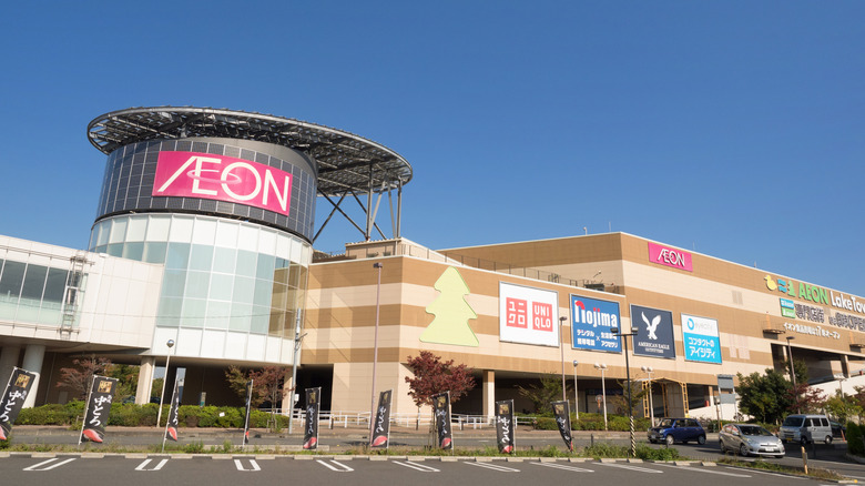 The front facade of Aeon LakeTown shopping mall with signs for shops.