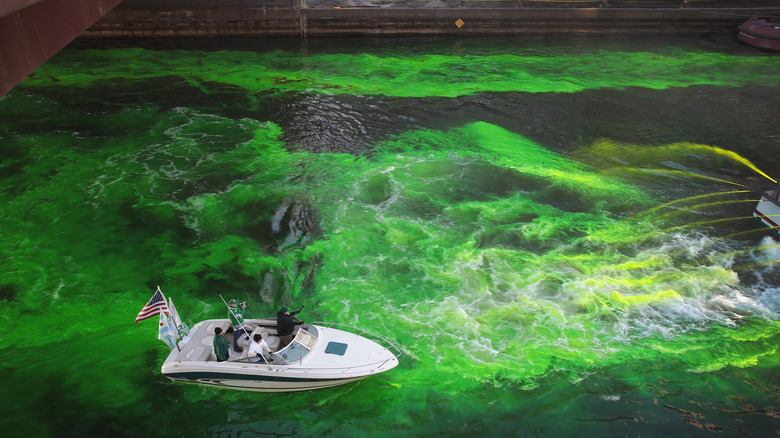 A boat spraying the Chicago River green