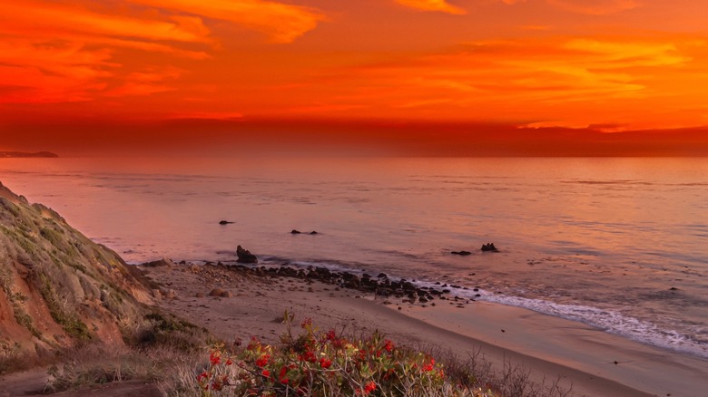 Rocky beach with blazing red sunset at El Matador State Beach, California