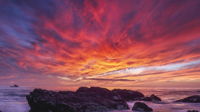 Sunset over beach with large rocks