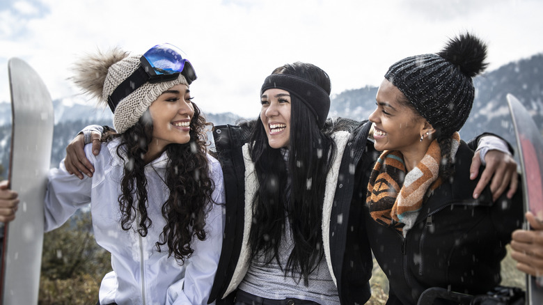 A group of young women snowboarding in Big Bear, California.
