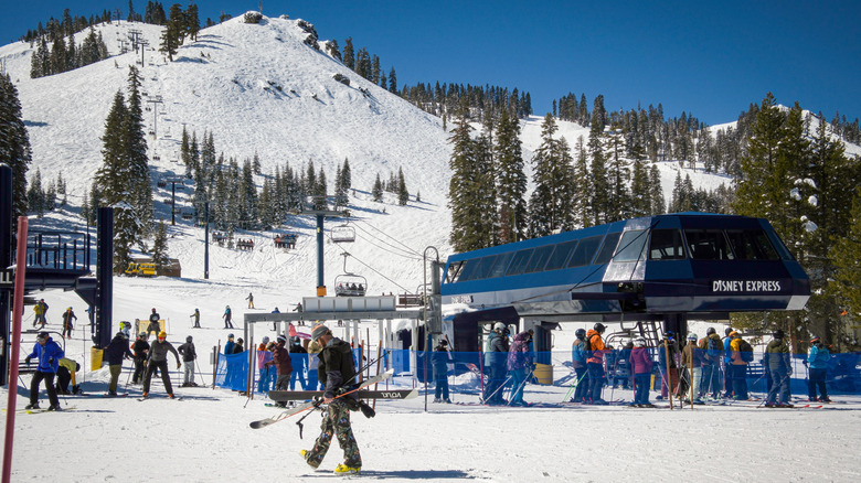 A man walks with his skis past the Disney Express chairlift at Sugar Bowl Resort.