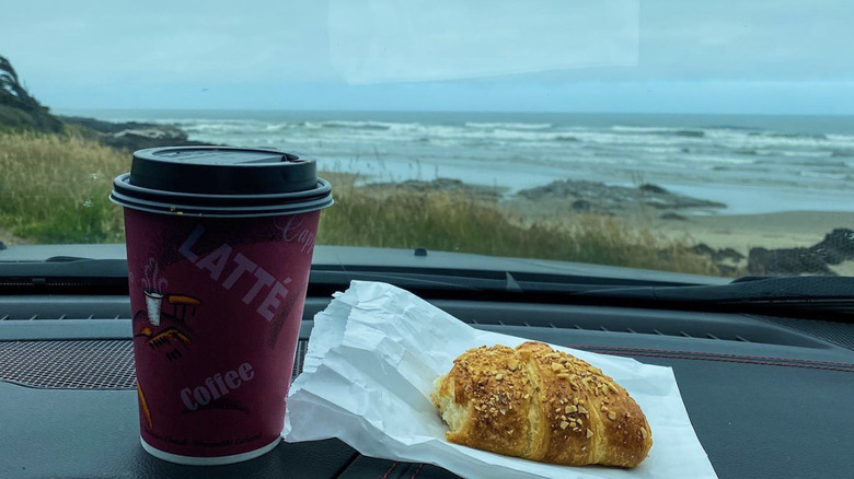 Bread & Roses Bakery latte and food on the hood of a car on the Oregon coast