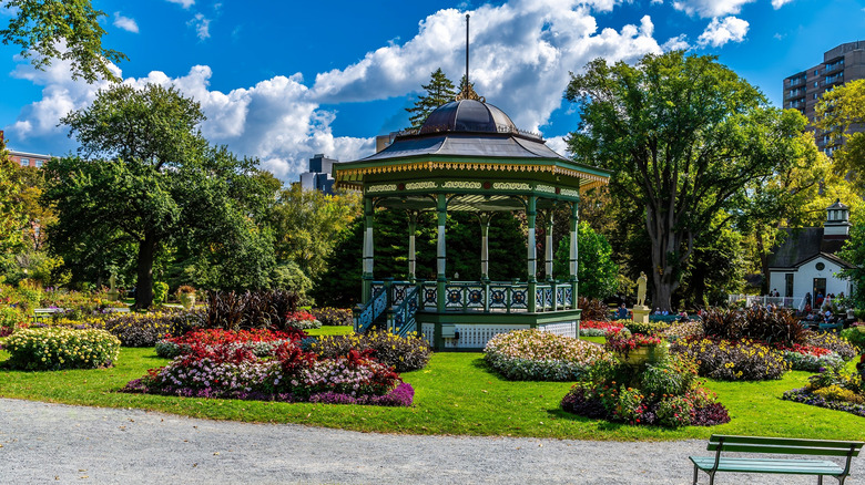 Gazebo surrounded by lush greenery and flowers in Halifax Public Gardens, Nova Scotia