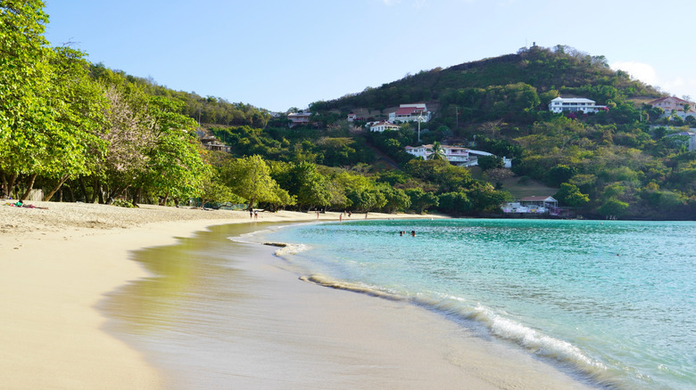 A view of the sandy crescent and clear waters of Morne Rouge Beach