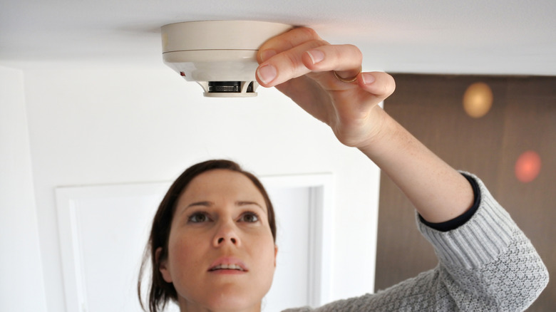 Woman with smoke detector