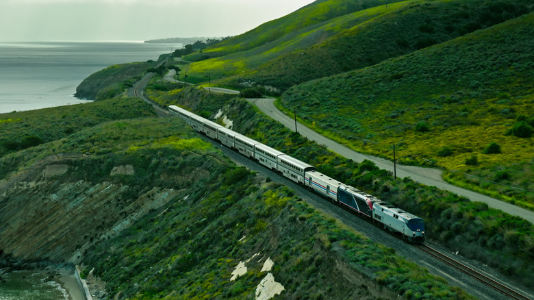 Aerial view of a passenger train traveling along the California Coast