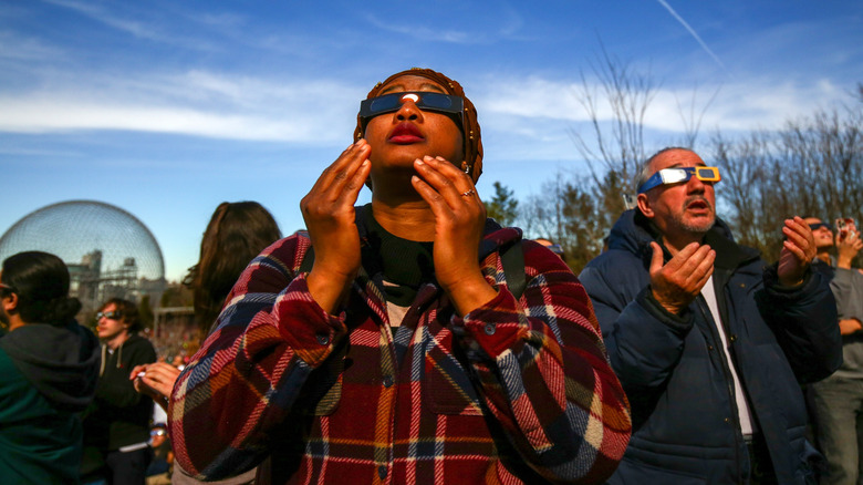 People looking at a solar eclipse