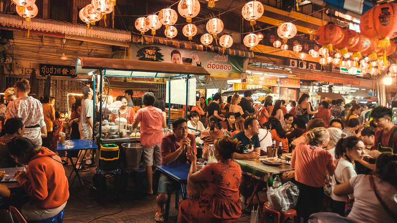 Street restaurants in Thailand with many customers sitting at tables