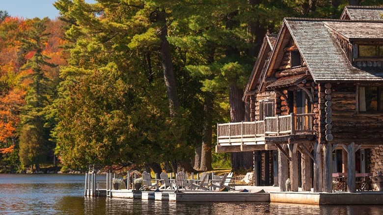 A lodge surrounded by trees on a lake