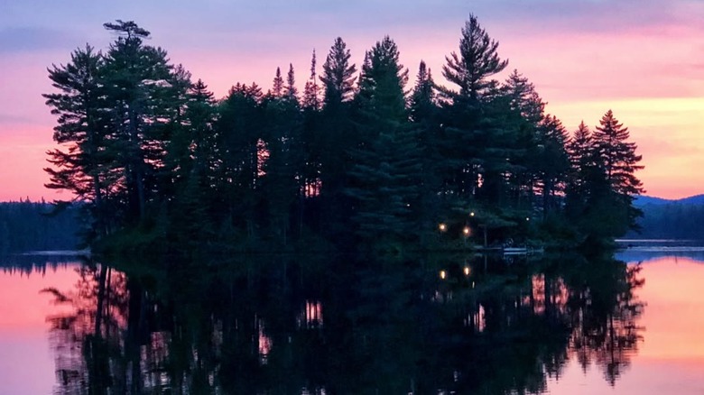 Sunset on a lake with trees reflecting