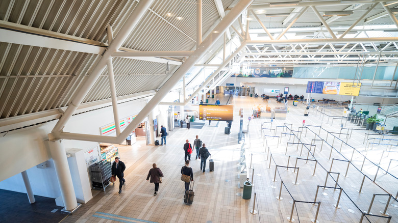 Travelers passing through a terminal in a Stockholm airport