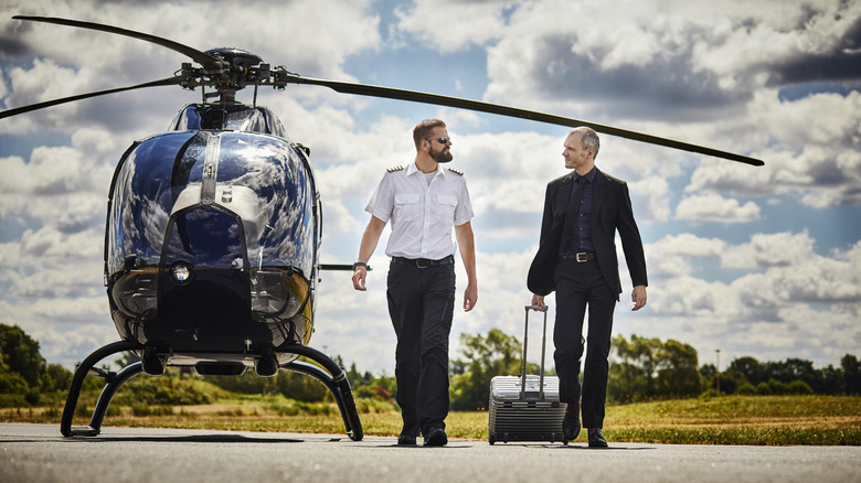 A helicopter pilot and passenger