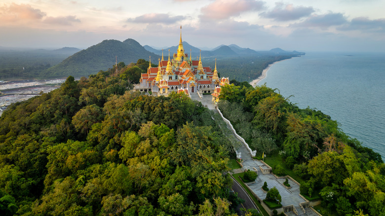 Sunset image of pagodas on a hill at the Wat Tang Sai temple, a beautiful Buddhist temple in Bang Saphan, Thailand