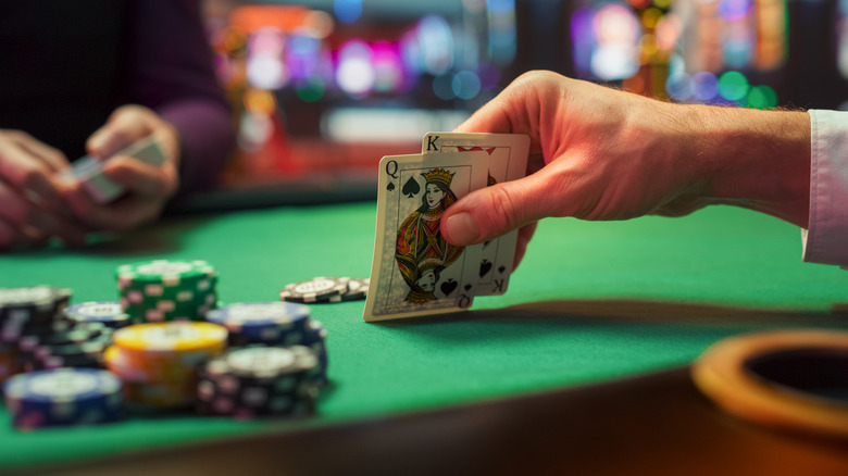 Mans hands and cards on a casino table