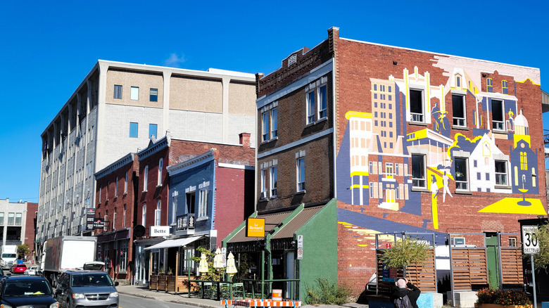 A street in Trois-Rivières lined with buildings and a vibrant mural