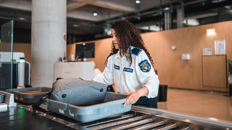 TSA agent checks bag
