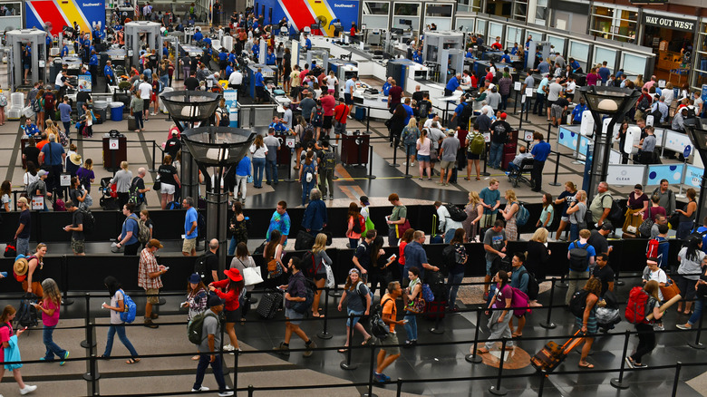 Crowds of travelers in long queue at TSA Security Check at Denver International Airport