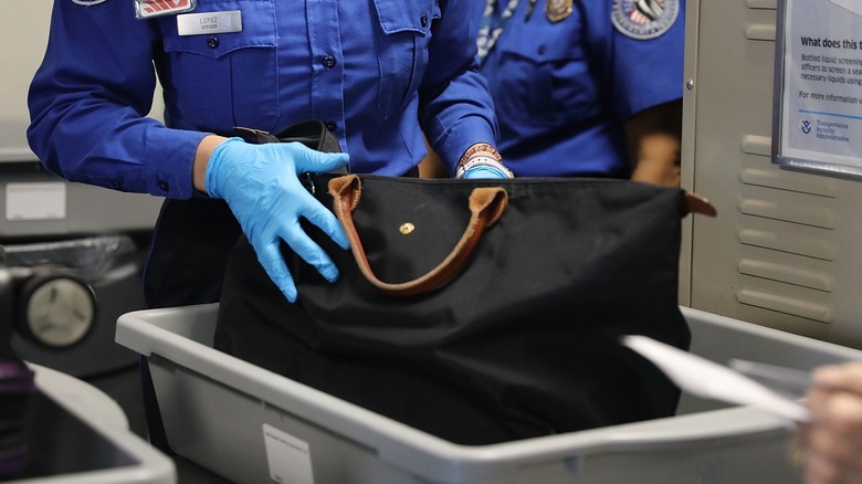 TSA agents searching a bag