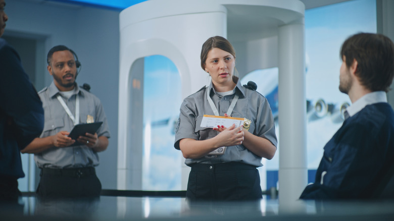Airport security officers talking among each other