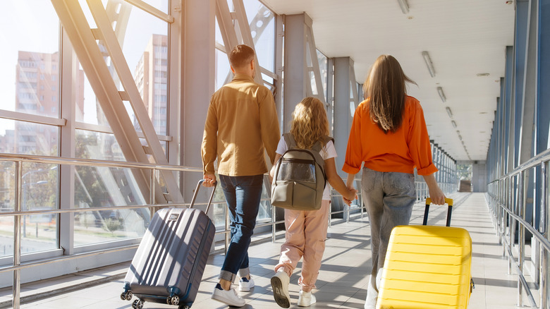 a family walking through an airport